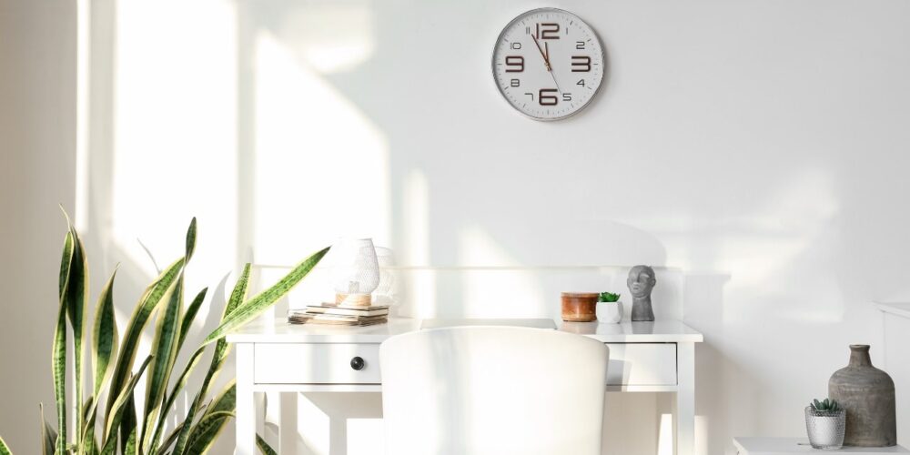 Reloj de pared con luz natural simbolizando los beneficios de no cambiar la hora.