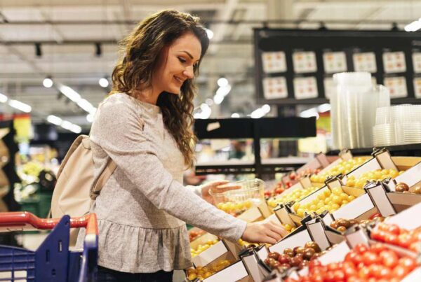 Persona eligiendo frutas y verduras en el supermercado tras usar medicamentos GLP-1