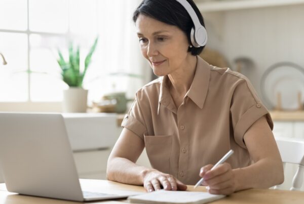 Persona adulta estudiando un nuevo idioma con libros y aplicación móvil, mostrando aprendizaje a cualquier edad